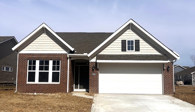 view of front of property featuring driveway, brick siding, roof with shingles, and an attached garage