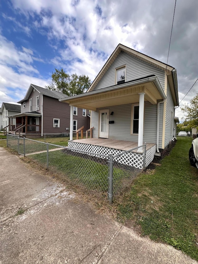 bungalow with a front lawn and a porch