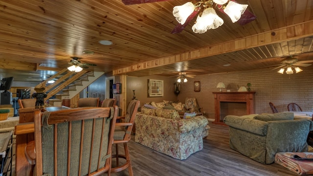 living room featuring wooden ceiling, dark wood-type flooring, and brick wall