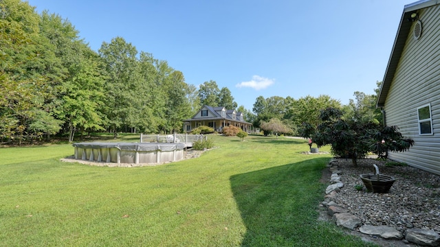 view of yard featuring a covered pool