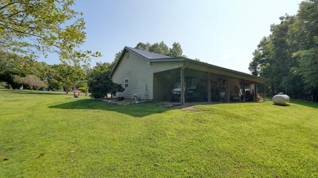 exterior space featuring a carport and a lawn