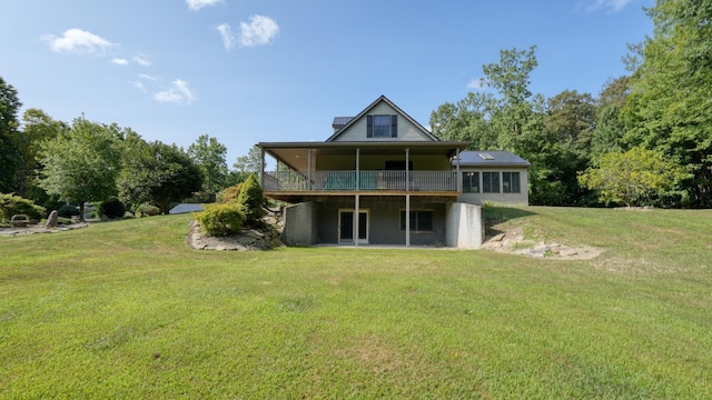 back of property with a yard and a wooden deck