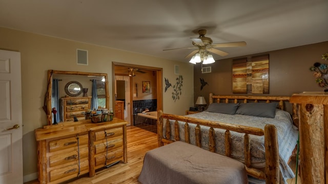 bedroom with ceiling fan and light hardwood / wood-style floors