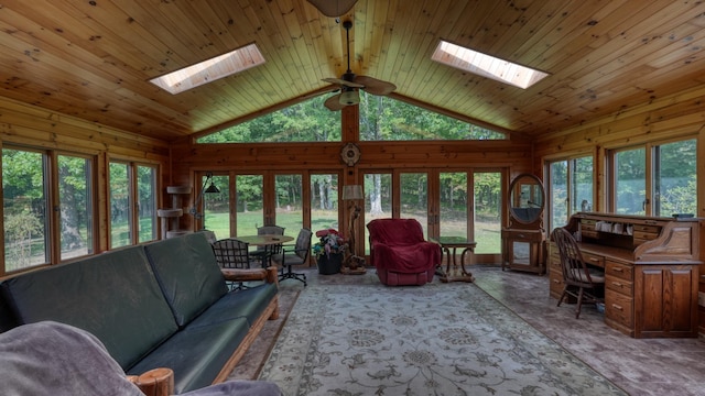 living room featuring a skylight, ceiling fan, french doors, and wood walls