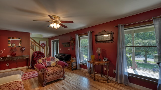 living area with hardwood / wood-style flooring and ceiling fan