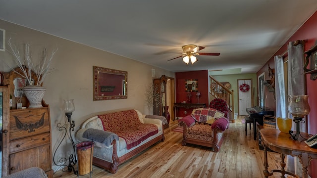 living room featuring light hardwood / wood-style floors and ceiling fan