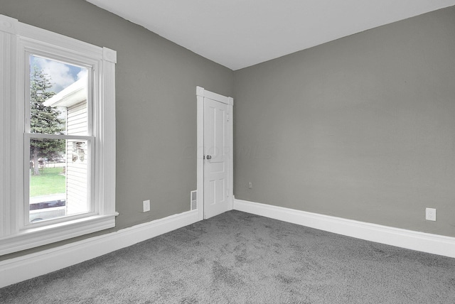 carpeted spare room with baseboards