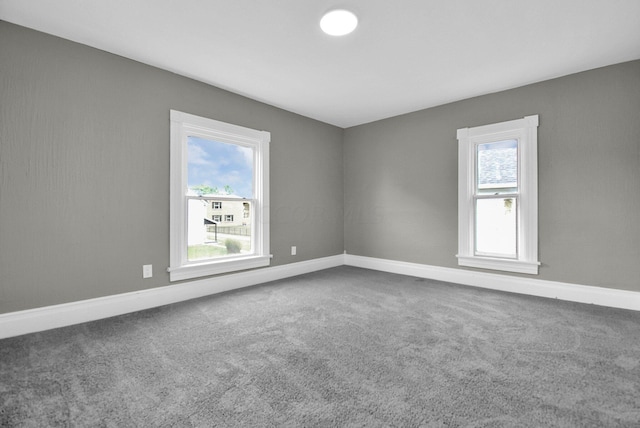 spare room with carpet flooring and baseboards