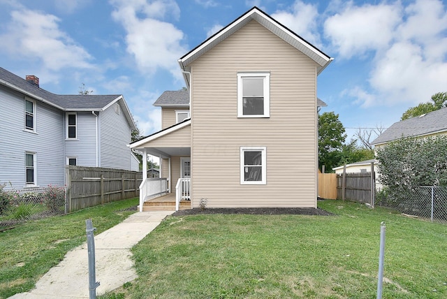 view of front of house featuring covered porch, a fenced backyard, and a front lawn