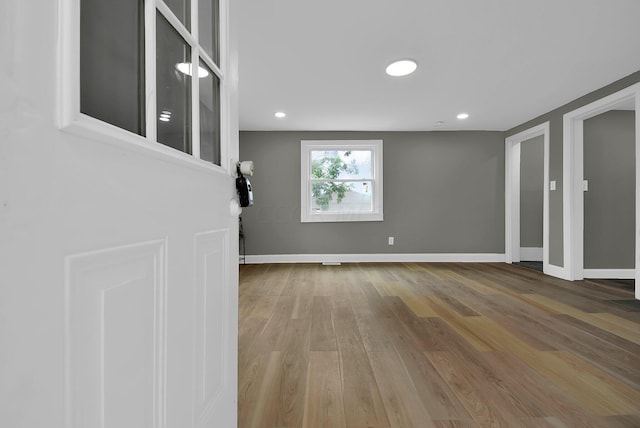 interior space featuring recessed lighting, baseboards, and wood finished floors