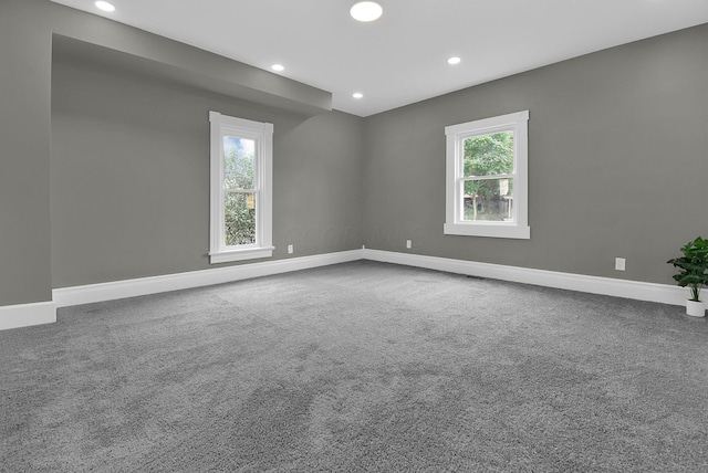 carpeted spare room with recessed lighting, baseboards, and a healthy amount of sunlight