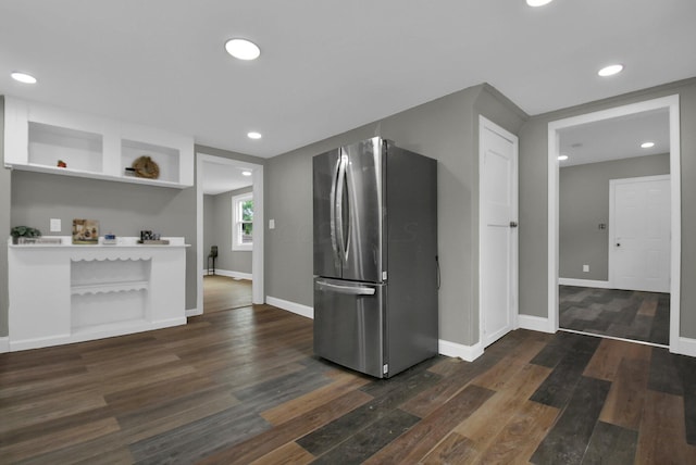 kitchen featuring dark wood finished floors, freestanding refrigerator, baseboards, and open shelves