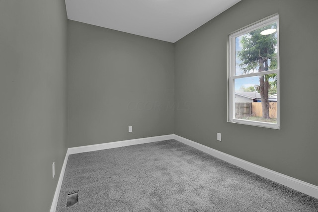 unfurnished room with baseboards and carpet floors