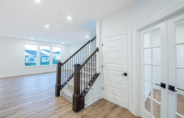 staircase with wood-type flooring