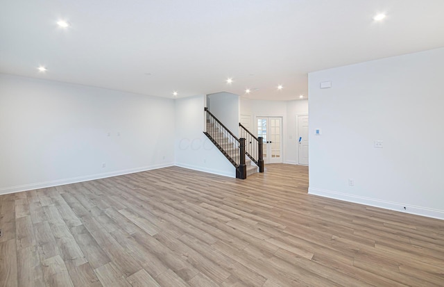 spare room with french doors and light wood-type flooring