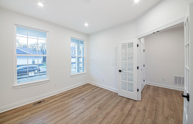 unfurnished room with light hardwood / wood-style flooring and french doors