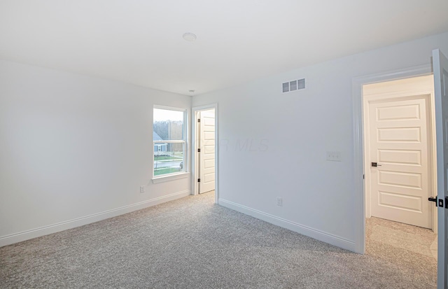 unfurnished room with light colored carpet