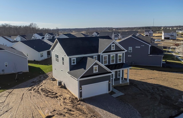 view of front of house with central AC and a garage