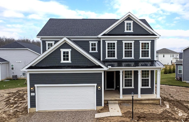 craftsman inspired home with covered porch and a garage