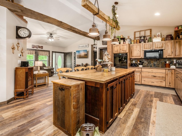 kitchen featuring a kitchen island, hardwood / wood-style floors, vaulted ceiling with beams, hanging light fixtures, and black appliances