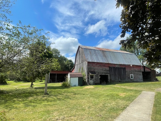 view of outbuilding featuring a yard