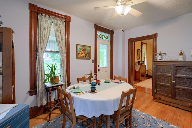 dining space featuring a textured ceiling, light hardwood / wood-style floors, plenty of natural light, and ceiling fan