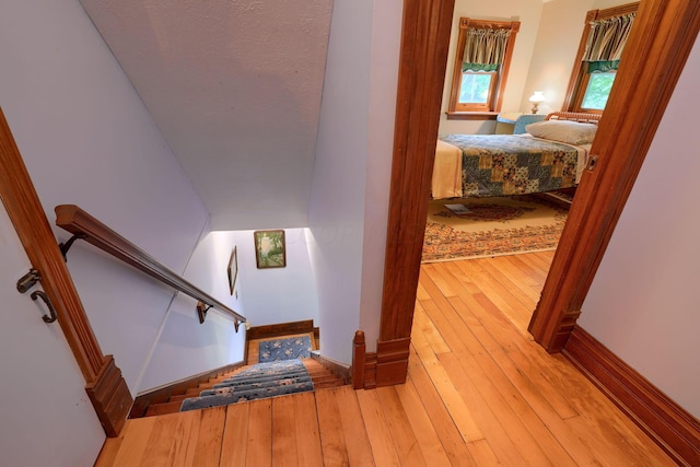 stairway with hardwood / wood-style flooring