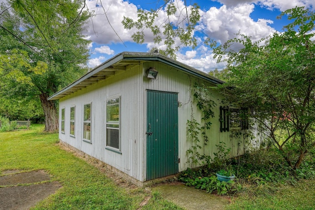 view of side of home with a lawn