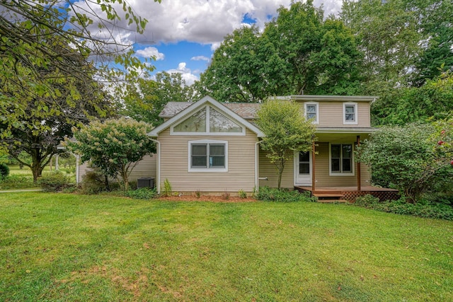 back of property with a yard and a porch