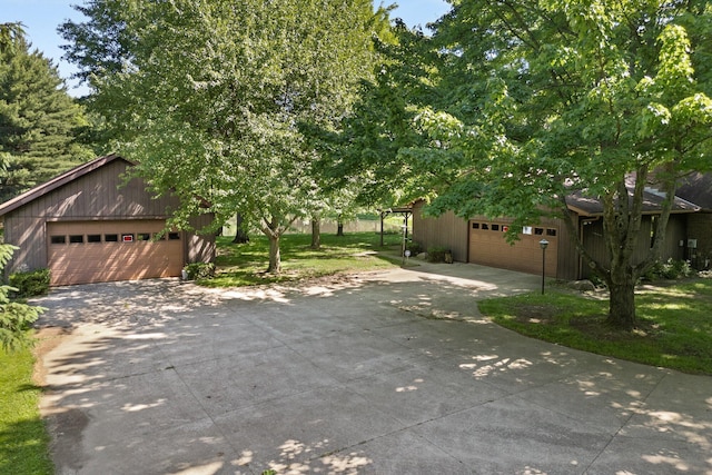 1980 Walker Lake Rd, Ontario, OH 44906 - obstructed view of property featuring a garage, an outdoor structure, and a front yard