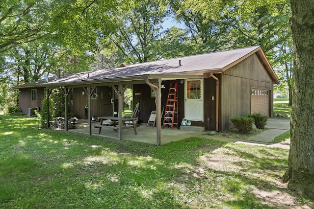1980 Walker Lake Rd, Ontario, OH 44906 - back of house featuring a yard, a patio, and a garage