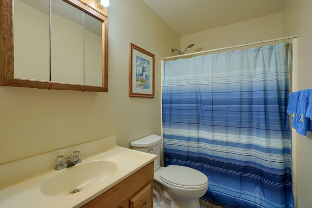 bathroom with vanity, toilet, and walk in shower