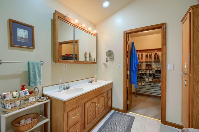 bathroom with vanity and vaulted ceiling