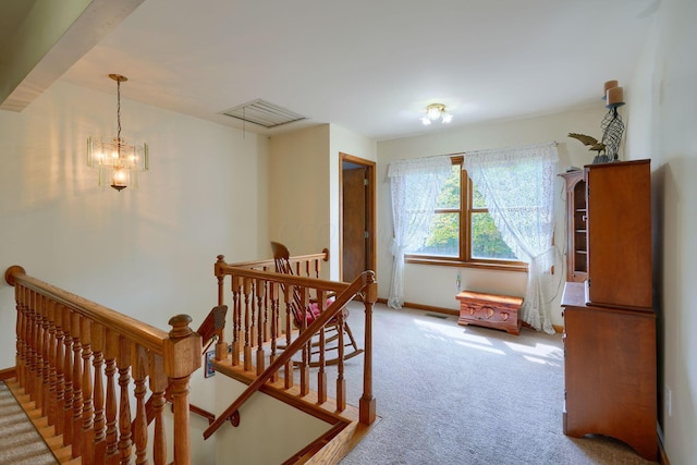 interior space featuring carpet flooring and an inviting chandelier