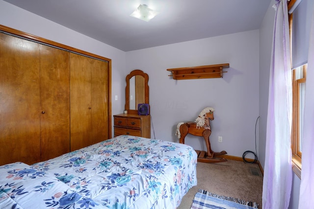 carpeted bedroom featuring a closet