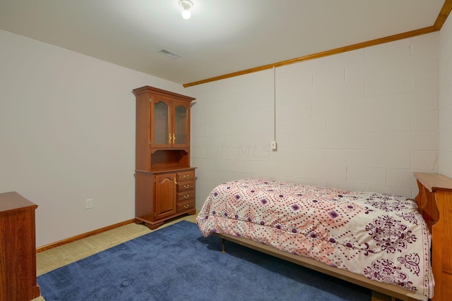 carpeted bedroom with ornamental molding