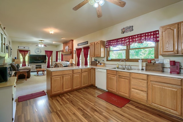 kitchen with dishwasher, sink, ceiling fan, light hardwood / wood-style floors, and kitchen peninsula