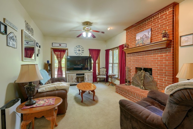 carpeted living room with ceiling fan and a brick fireplace