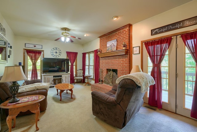 living room featuring plenty of natural light, light colored carpet, and a fireplace