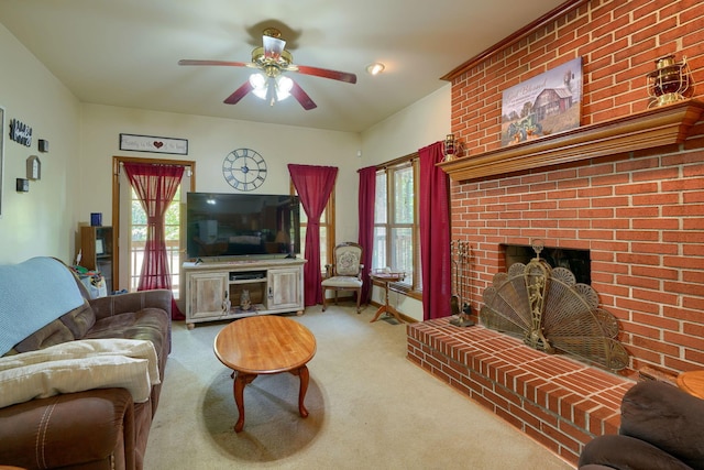 living room featuring ceiling fan, a wealth of natural light, carpet floors, and a brick fireplace