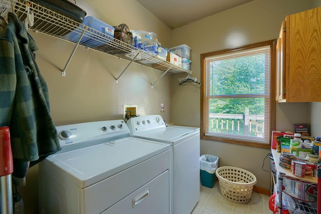 clothes washing area with cabinets and independent washer and dryer