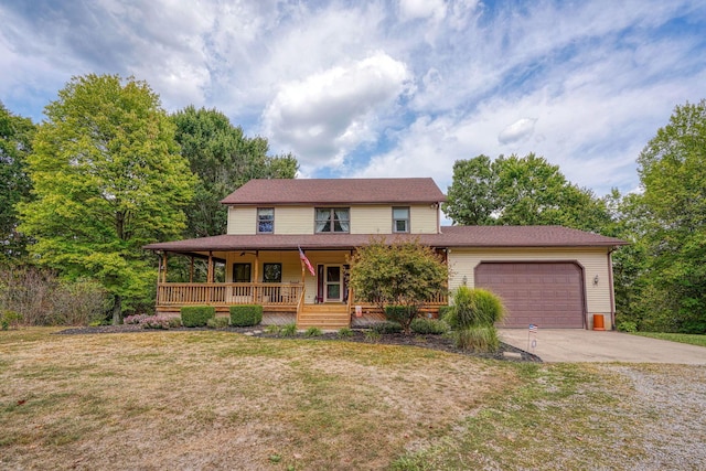 view of front of home with a front lawn, a porch, and a garage