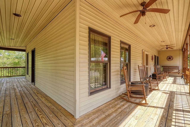 wooden terrace featuring ceiling fan and a porch