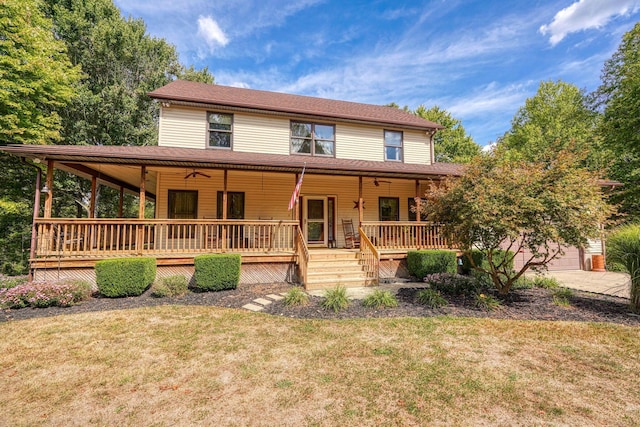 view of front of home featuring ceiling fan, a porch, and a front yard