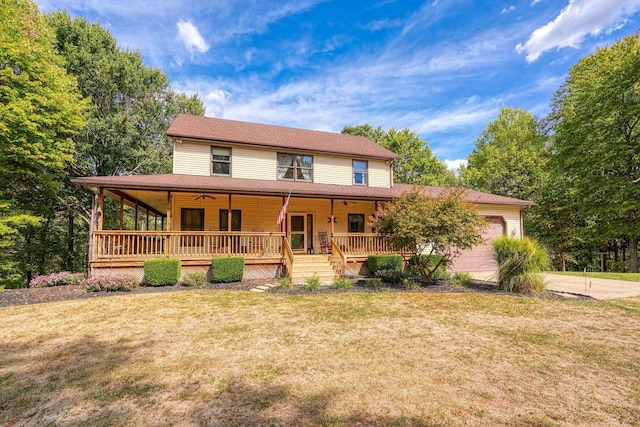 country-style home featuring a garage, covered porch, and a front yard