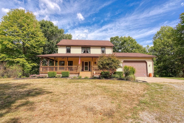 view of front facade featuring a garage, covered porch, and a front lawn