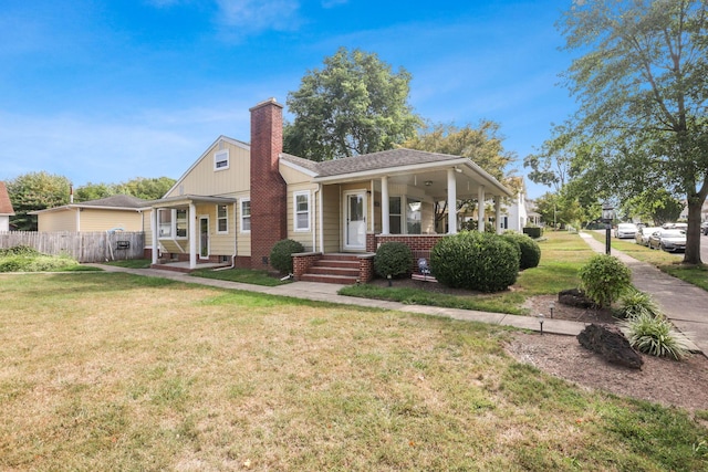 view of front facade with covered porch and a front lawn