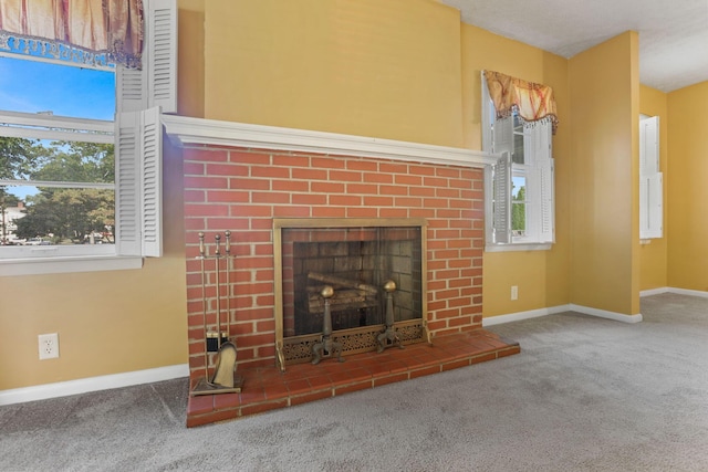 unfurnished living room featuring a fireplace and carpet floors