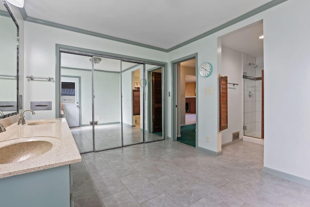 bathroom with crown molding, a shower with door, and vanity