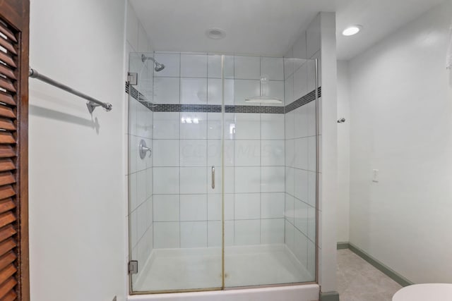 bathroom featuring tile patterned floors and a shower with shower door